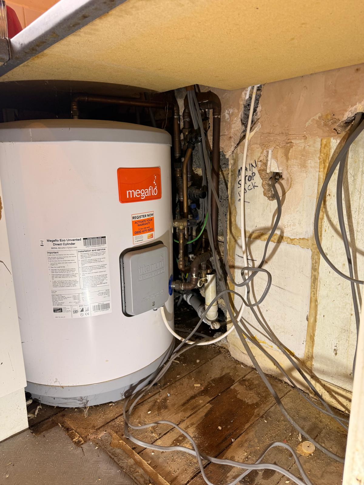 Megaflo unvented cylinder mid-installation with first-fix pipework and wiring