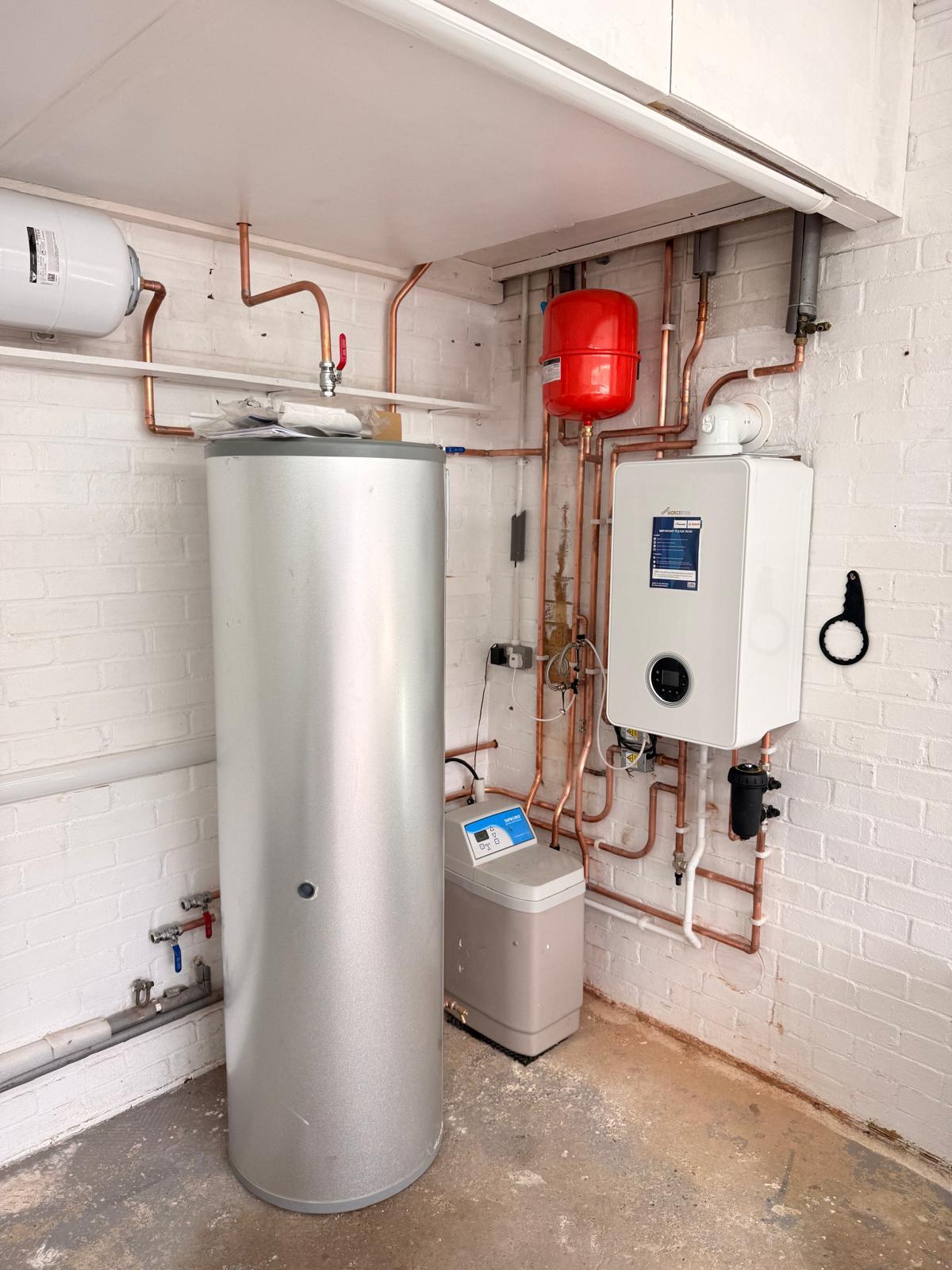 Unvented hot water cylinder and boiler with neat copper pipework