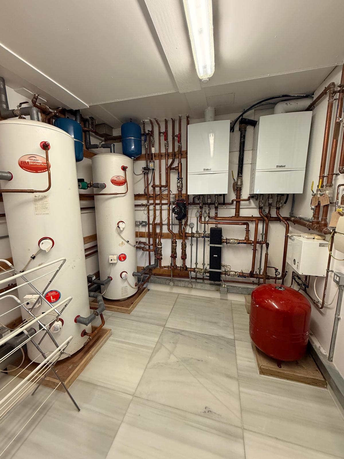 Plant room with two boilers, two unvented cylinders and neat copper pipework